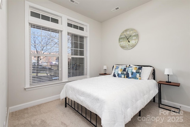 carpeted bedroom featuring visible vents and baseboards