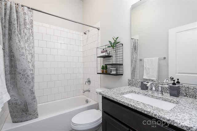 full bathroom with vanity, shower / bath combo with shower curtain, and toilet