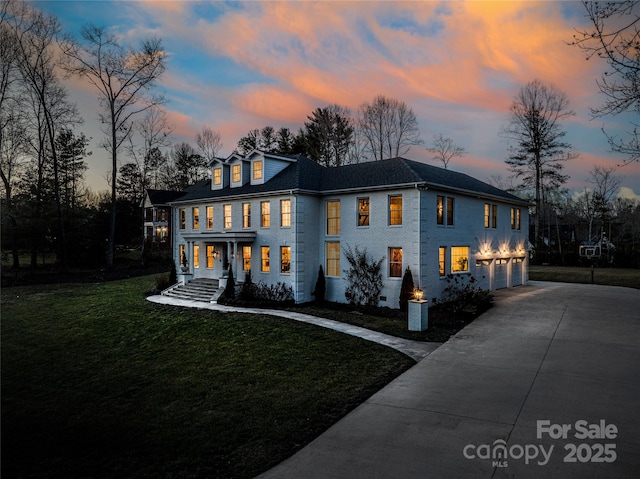 exterior space featuring a garage, driveway, and a yard