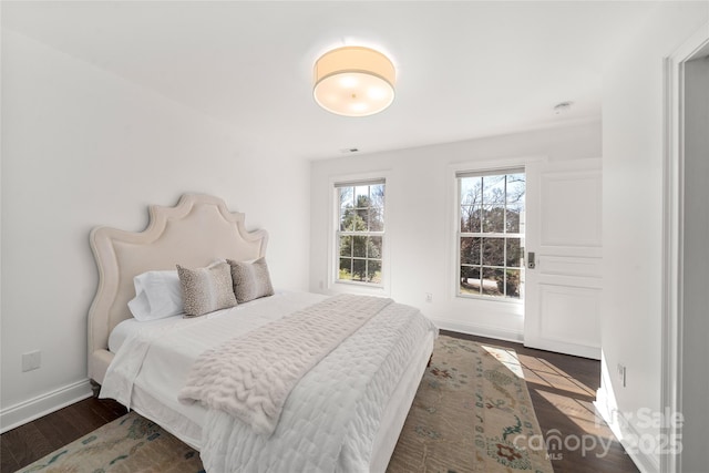 bedroom with wood finished floors and baseboards