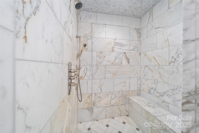 full bath with a tile shower