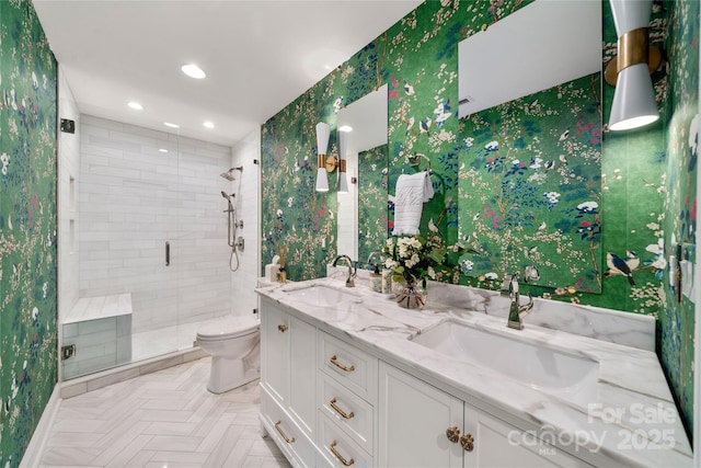 full bathroom featuring double vanity, a sink, toilet, and a shower stall