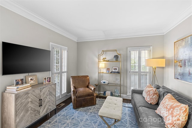 living room featuring plenty of natural light, wood finished floors, and ornamental molding