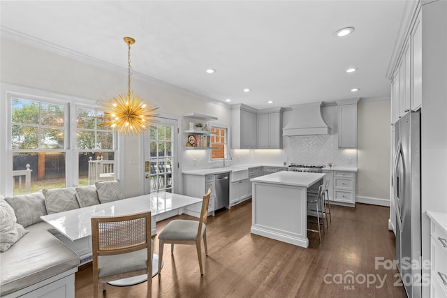 kitchen featuring dark wood-type flooring, ornamental molding, open shelves, appliances with stainless steel finishes, and custom exhaust hood