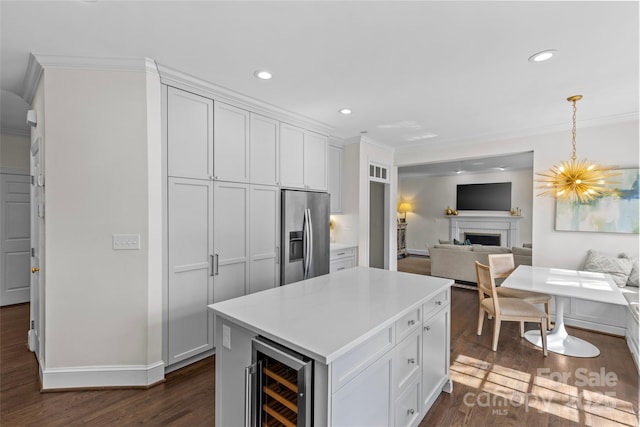 kitchen with dark wood-type flooring, wine cooler, open floor plan, and stainless steel fridge