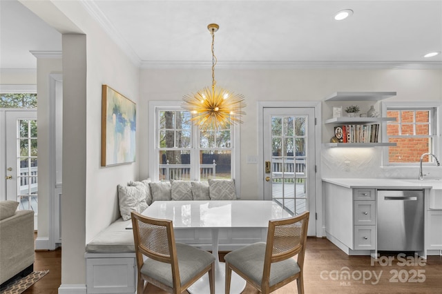 dining space featuring breakfast area, plenty of natural light, and dark wood-style flooring