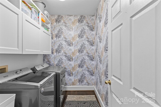 clothes washing area featuring baseboards, washer and dryer, dark wood-style floors, cabinet space, and a sink