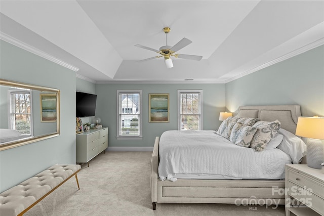 bedroom featuring baseboards, ceiling fan, crown molding, a raised ceiling, and light colored carpet