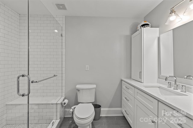 full bath with a shower stall, toilet, vanity, and baseboards