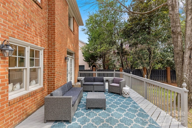 deck with outdoor lounge area and fence