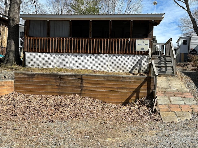 back of property featuring a porch