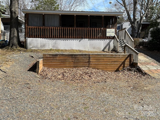 back of house with a sunroom and stairs