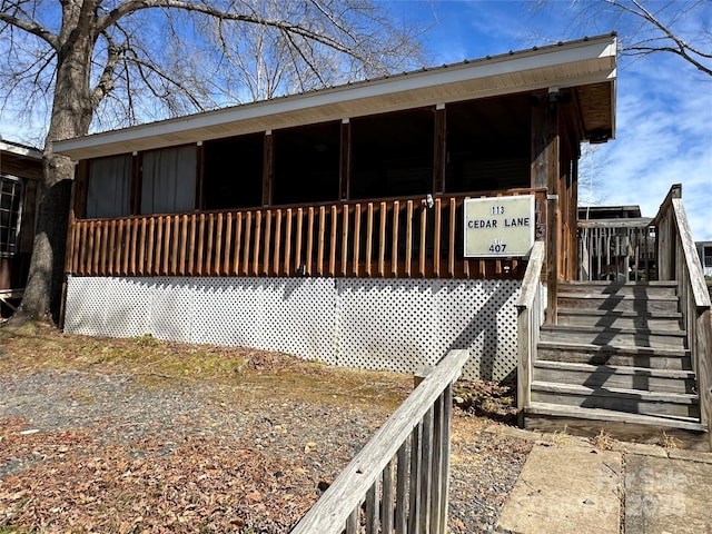 exterior space with stairway and a sunroom