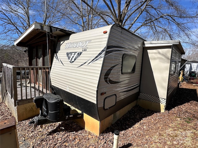 view of property exterior with a wooden deck