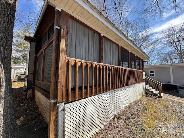 view of property exterior with a sunroom