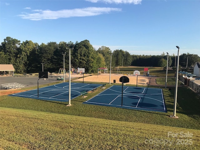 view of basketball court featuring community basketball court and a lawn