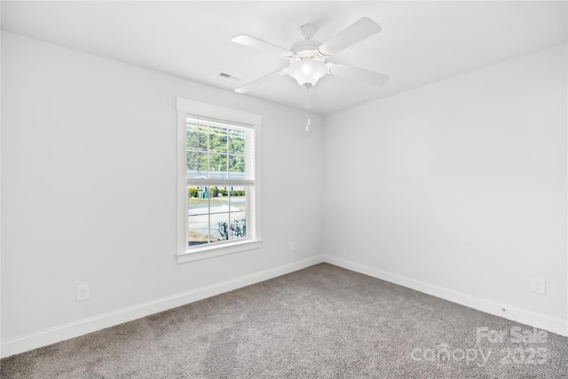 spare room featuring a ceiling fan, carpet flooring, visible vents, and baseboards