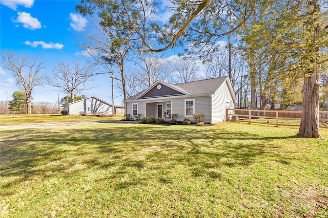 view of front of property with a front yard and fence