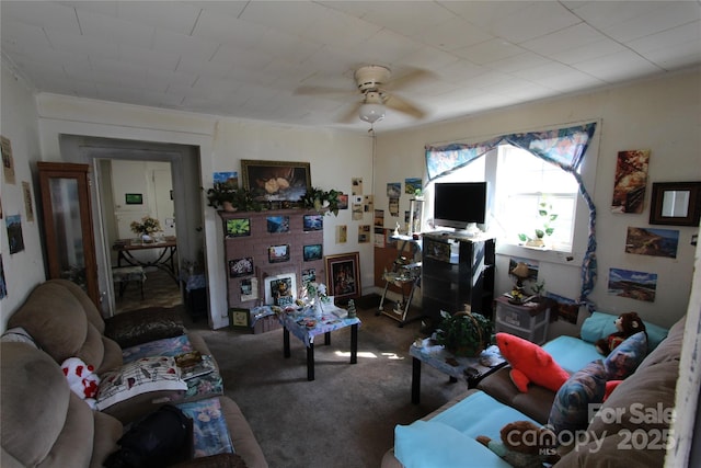 living area with carpet floors and ceiling fan