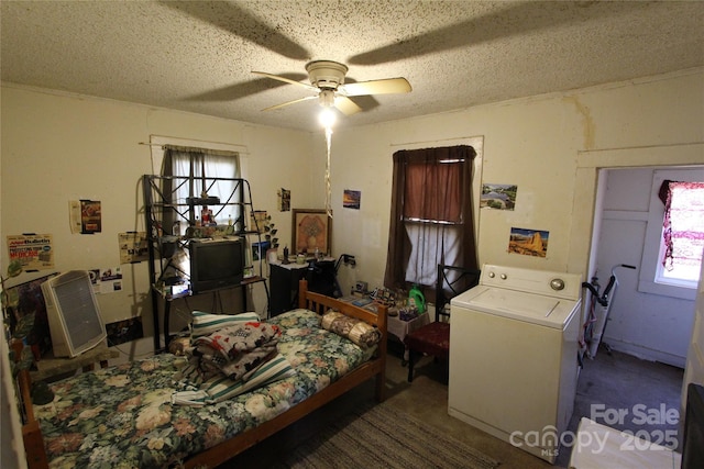 bedroom featuring washer / dryer and a textured ceiling