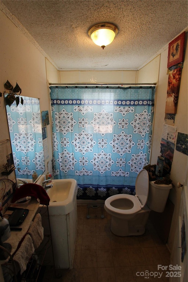 full bath featuring curtained shower, toilet, a textured ceiling, vanity, and tile patterned flooring