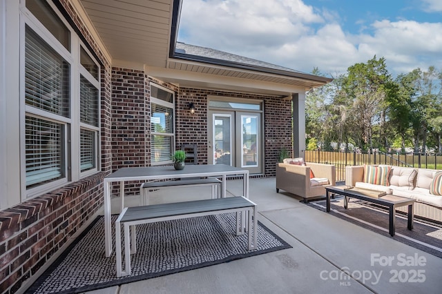 view of patio featuring fence and an outdoor hangout area