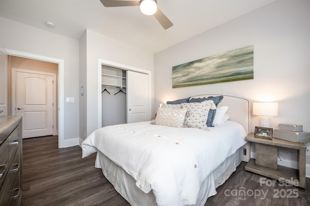 bedroom with dark wood-type flooring, a closet, ceiling fan, and baseboards