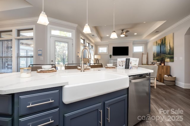 kitchen with a sink, open floor plan, stainless steel dishwasher, blue cabinetry, and ornamental molding