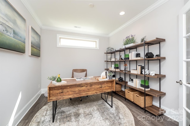 office featuring visible vents, crown molding, baseboards, and wood finished floors