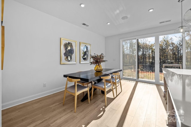 dining area with baseboards, recessed lighting, visible vents, and light wood-style floors