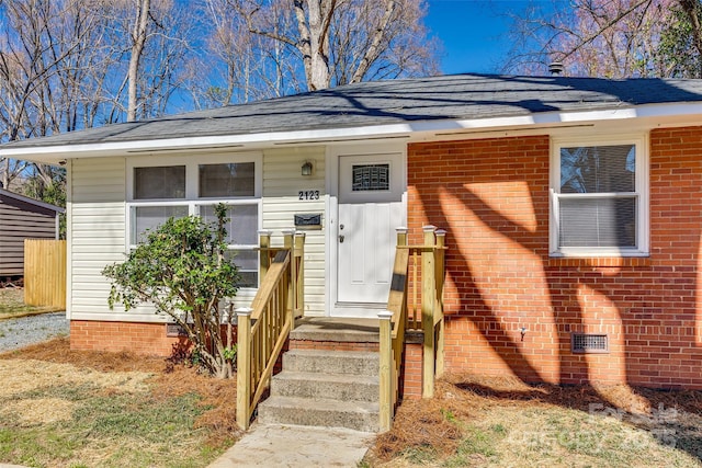 bungalow-style home with brick siding and crawl space