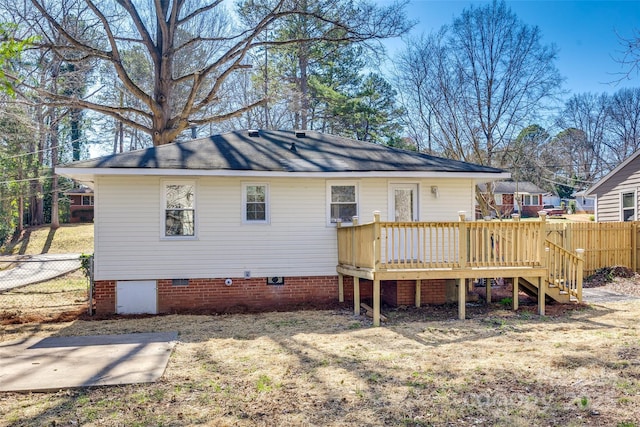 back of house with crawl space, fence, and a deck