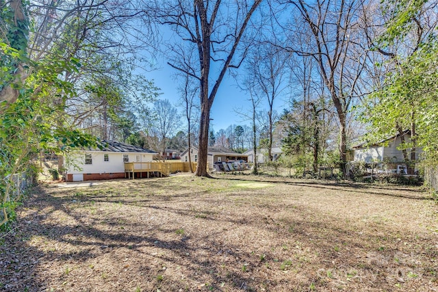 view of yard featuring fence and a deck