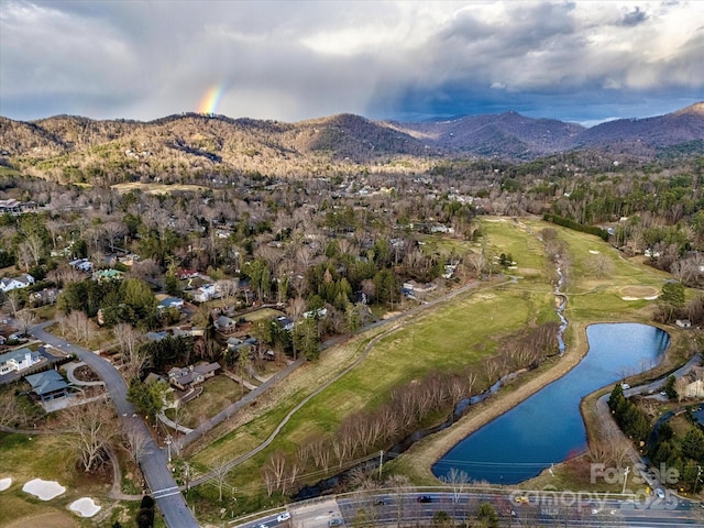 birds eye view of property with a water and mountain view