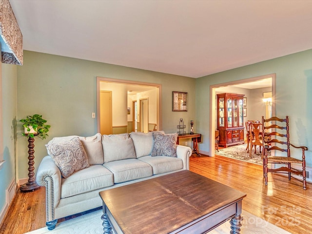 living area with light wood-style floors and baseboards