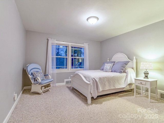 carpeted bedroom featuring visible vents and baseboards