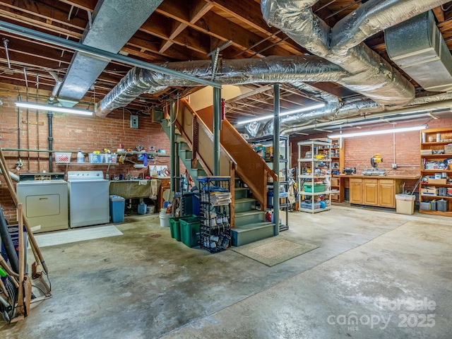 unfinished below grade area with brick wall, a workshop area, and independent washer and dryer