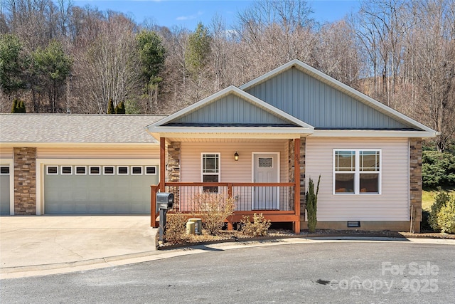 view of front of home with roof with shingles, a porch, board and batten siding, a garage, and driveway