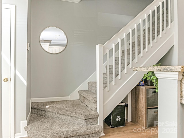 stairway with baseboards and wood finished floors