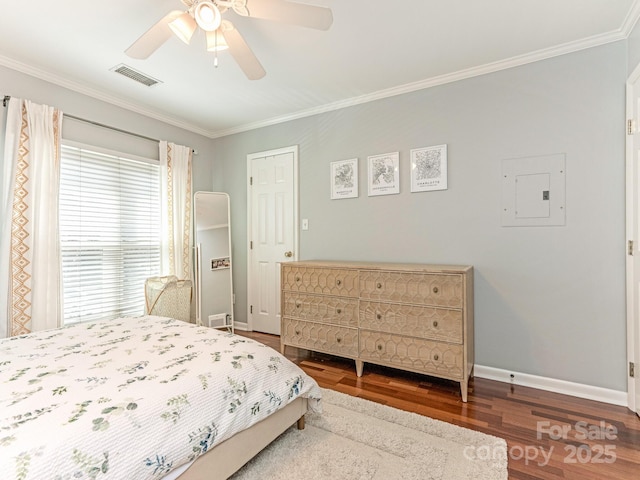 bedroom with electric panel, baseboards, visible vents, ornamental molding, and wood finished floors