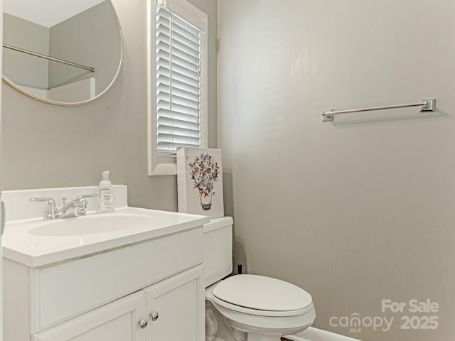 bathroom featuring toilet and vanity