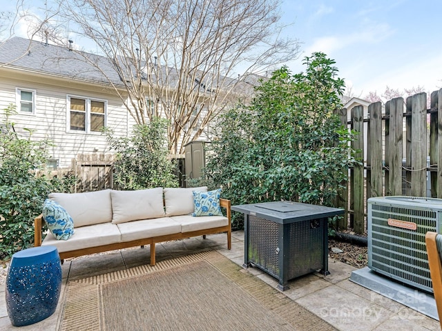 view of patio with fence, an outdoor living space, and cooling unit