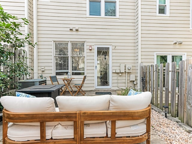 view of patio / terrace with central AC, fence, and an outdoor hangout area