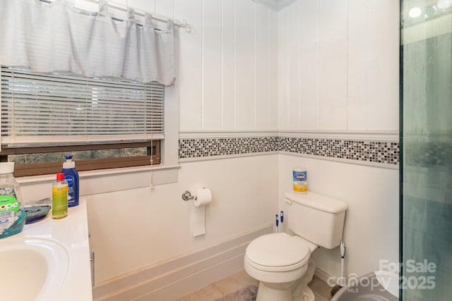 bathroom featuring toilet, a sink, and tile patterned floors