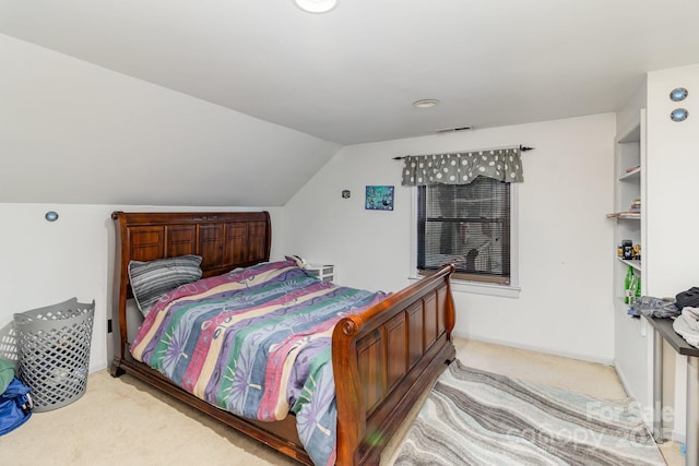 bedroom with light carpet, visible vents, and lofted ceiling