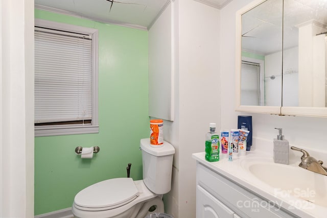 full bathroom featuring ornamental molding, vanity, and toilet