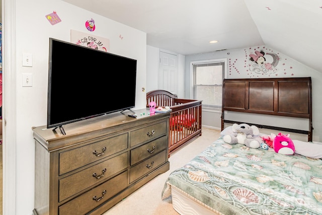 bedroom featuring light carpet and vaulted ceiling