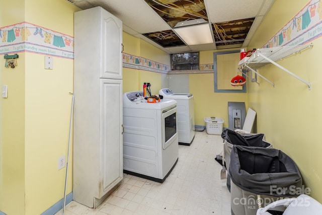 laundry room featuring cabinet space, separate washer and dryer, and light floors