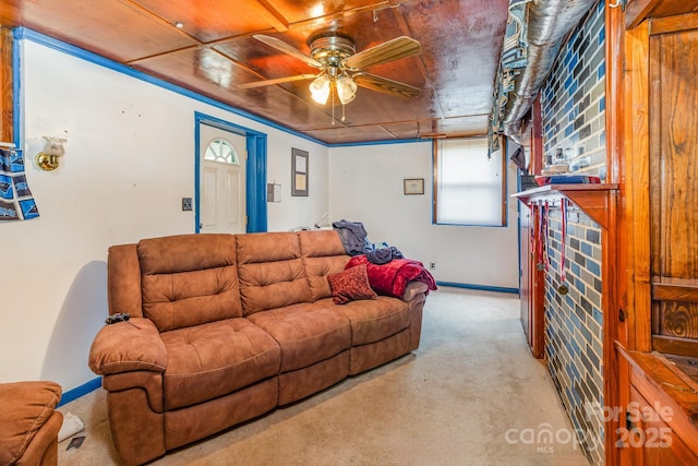 living room with carpet flooring, a ceiling fan, and baseboards