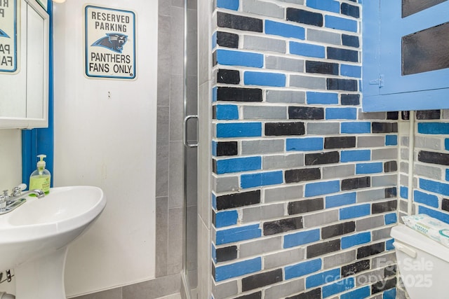 bathroom with a stall shower and toilet